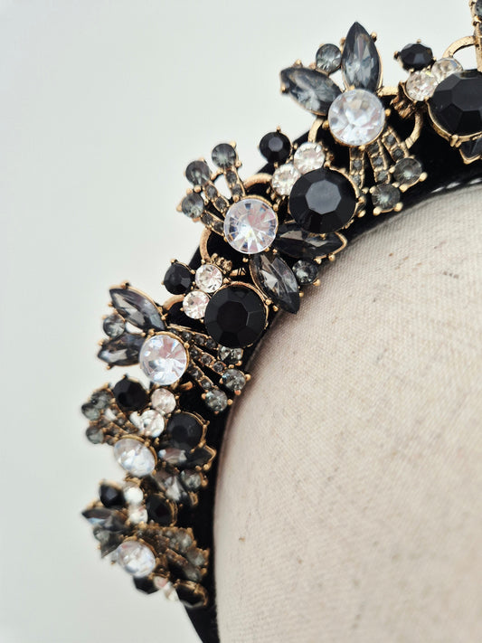close up black rhinestone headband on a manniquin head against a white baqckground