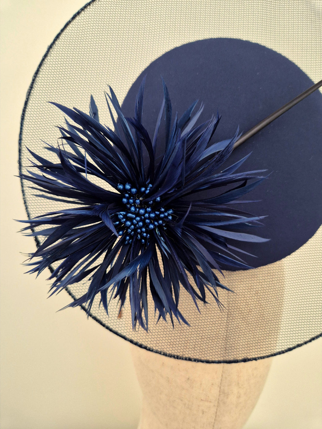 close up navy blue percher with flower