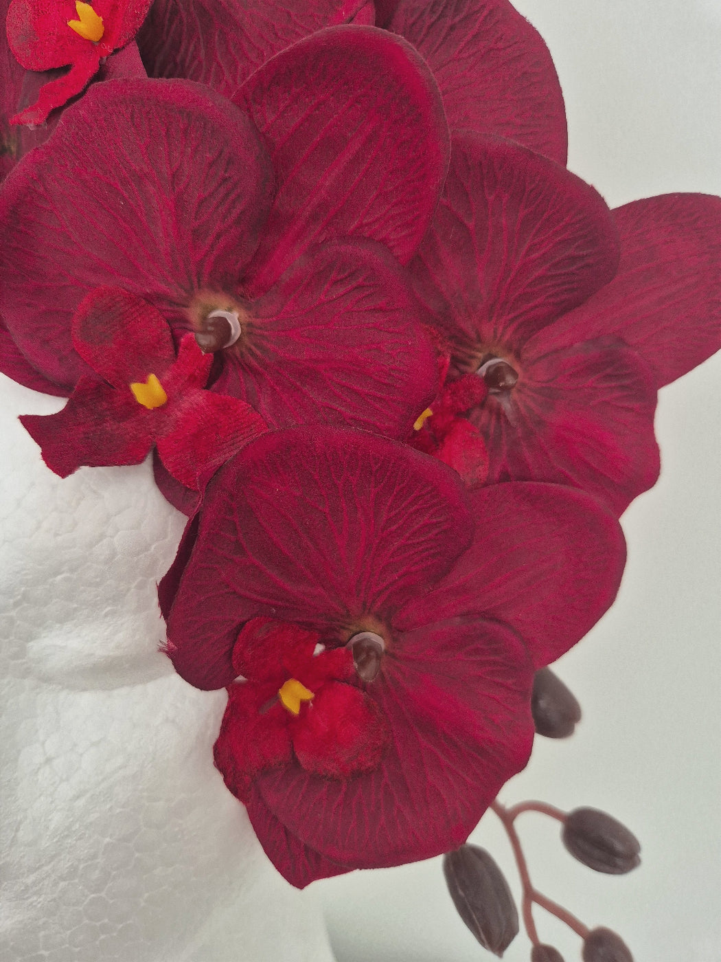 close up of burgundy orchid floral headpiece