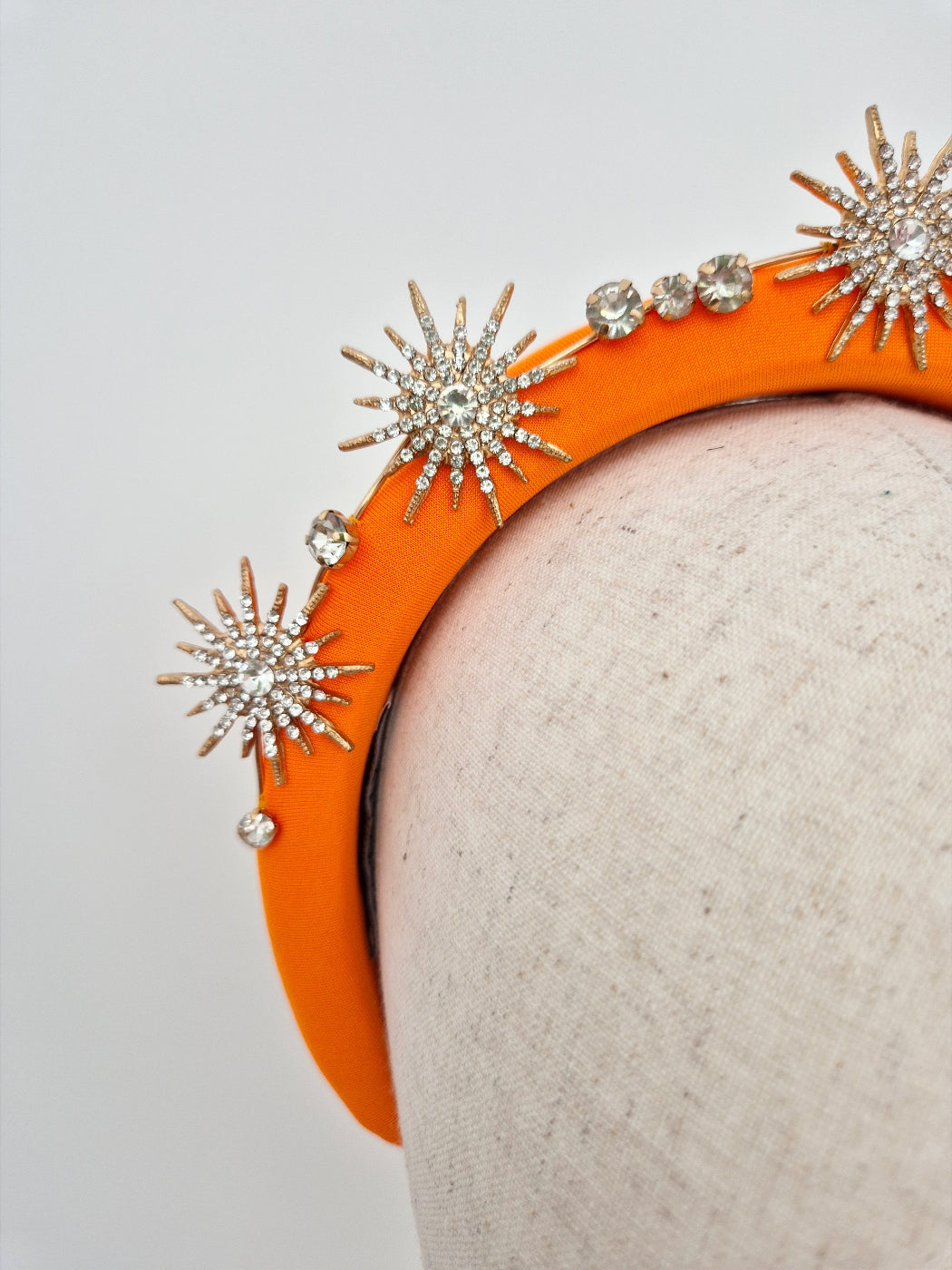 close up orange headband with gold stars