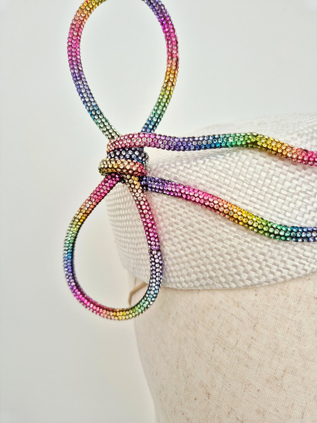 close up of rhinestone bow on pillbox hat