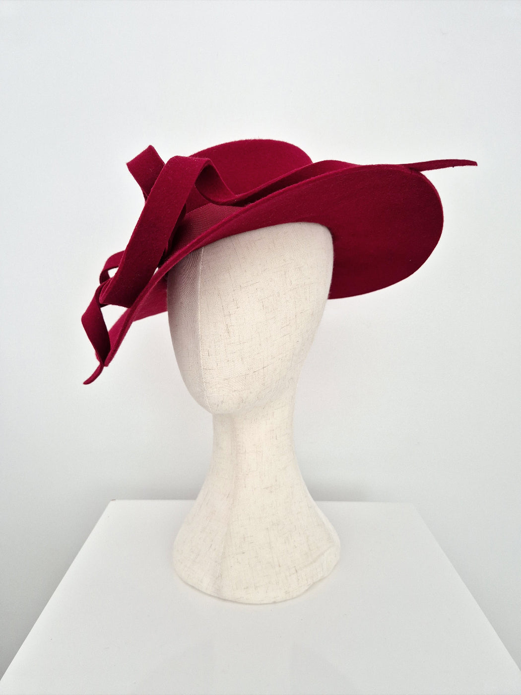 dark Red hat on a mannequin head against a white background side view