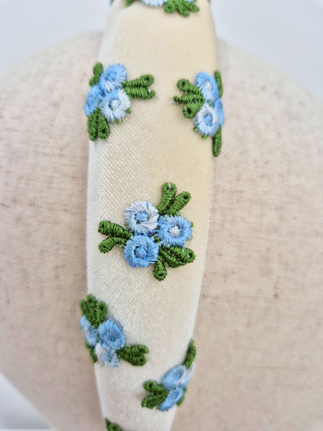 embroidered blue rose buds on ivory velvet headband close up