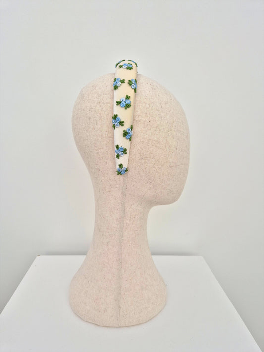 embroidered blue rose buds on a ivory velvet headband side view