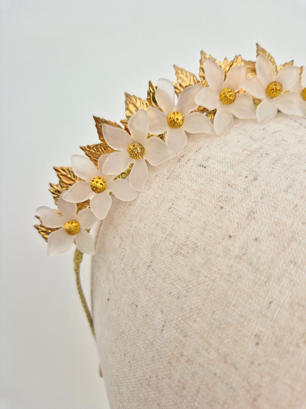 gold and white floral crown close up