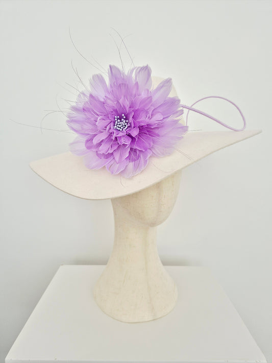 ivory felt hat with a large purple flower on a white background side view