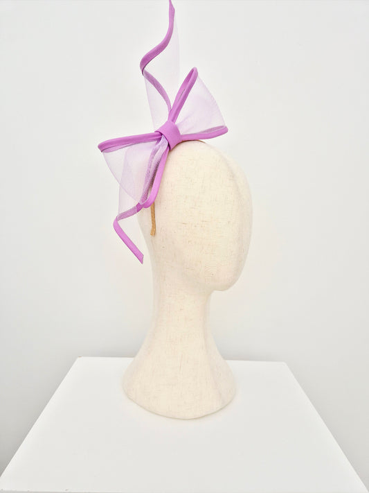 lavender bow headpiece on a mannequin head against a white background side view