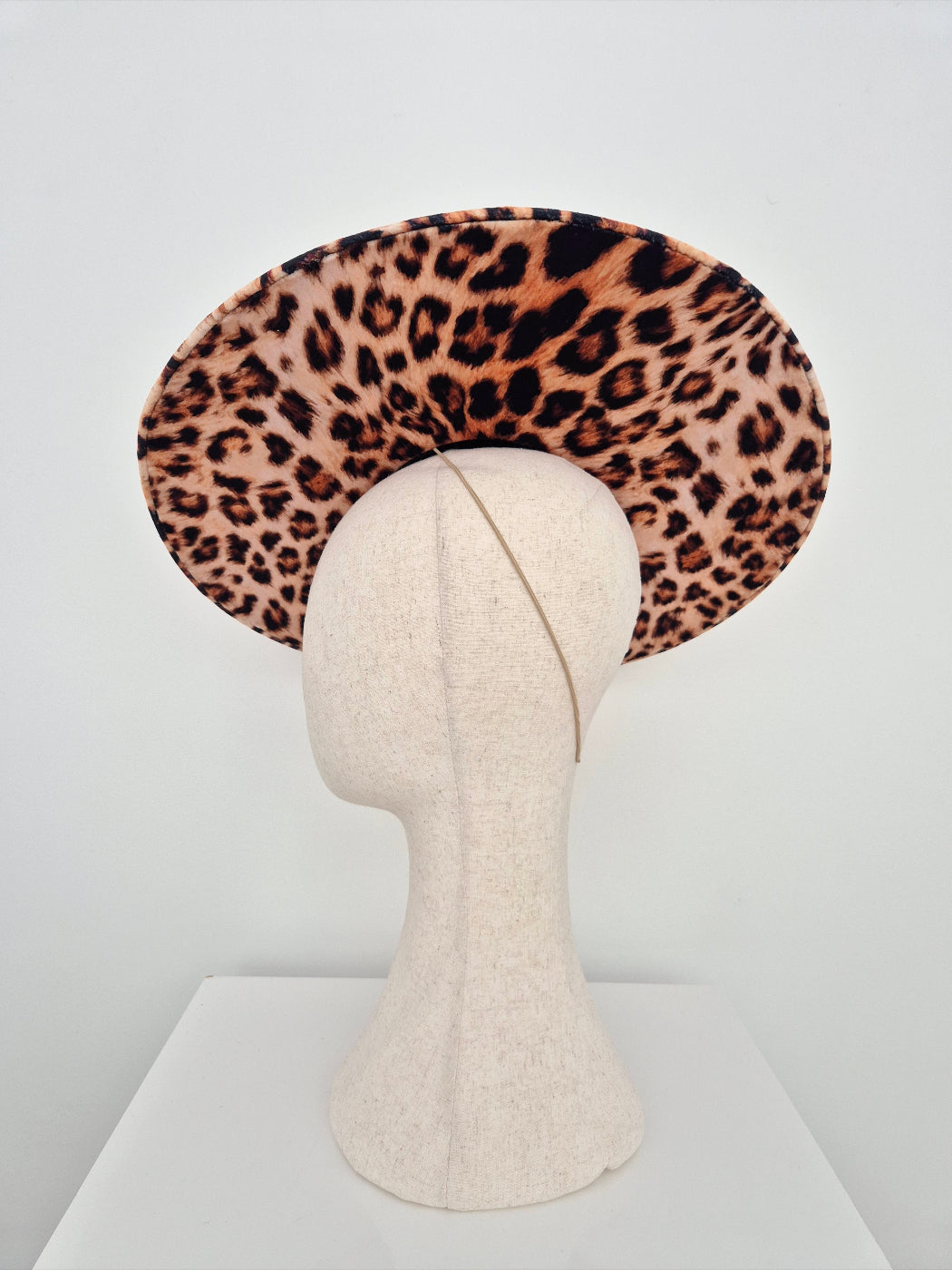 Leopard print hat on a mannequin head against a white background side view 2
