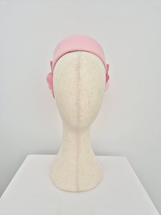 Pink pillbox headpiece on a mannequin head against a white background front view