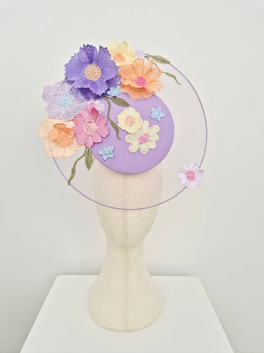 lilac and Pastel floral headpiece  on a mannequin head against a white background