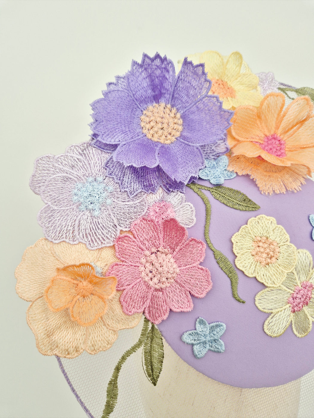Colorful embroidered flowers on a fabric background close up