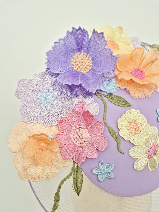 Colorful embroidered flowers on a fabric background close up