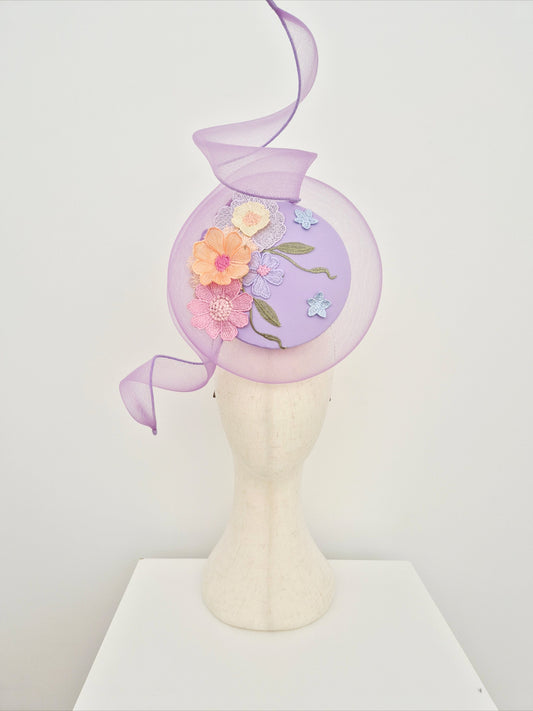 lilac-percher-headpiece-with-lace-detail on a manniquin head against a white wall