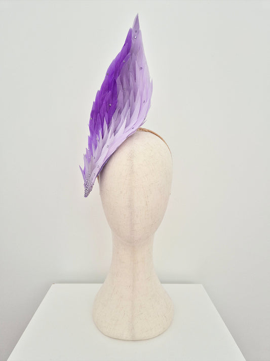 Lilac ombre feathered headpiece on a mannequin head against a white background