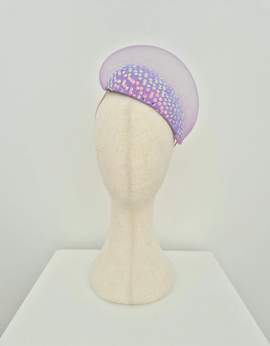 Lilac headpiece with sequin details on a mannequin head against a white background front