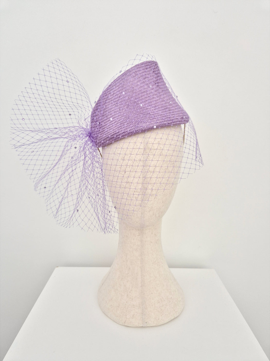 lilac straw slanted headpiece with veiling 