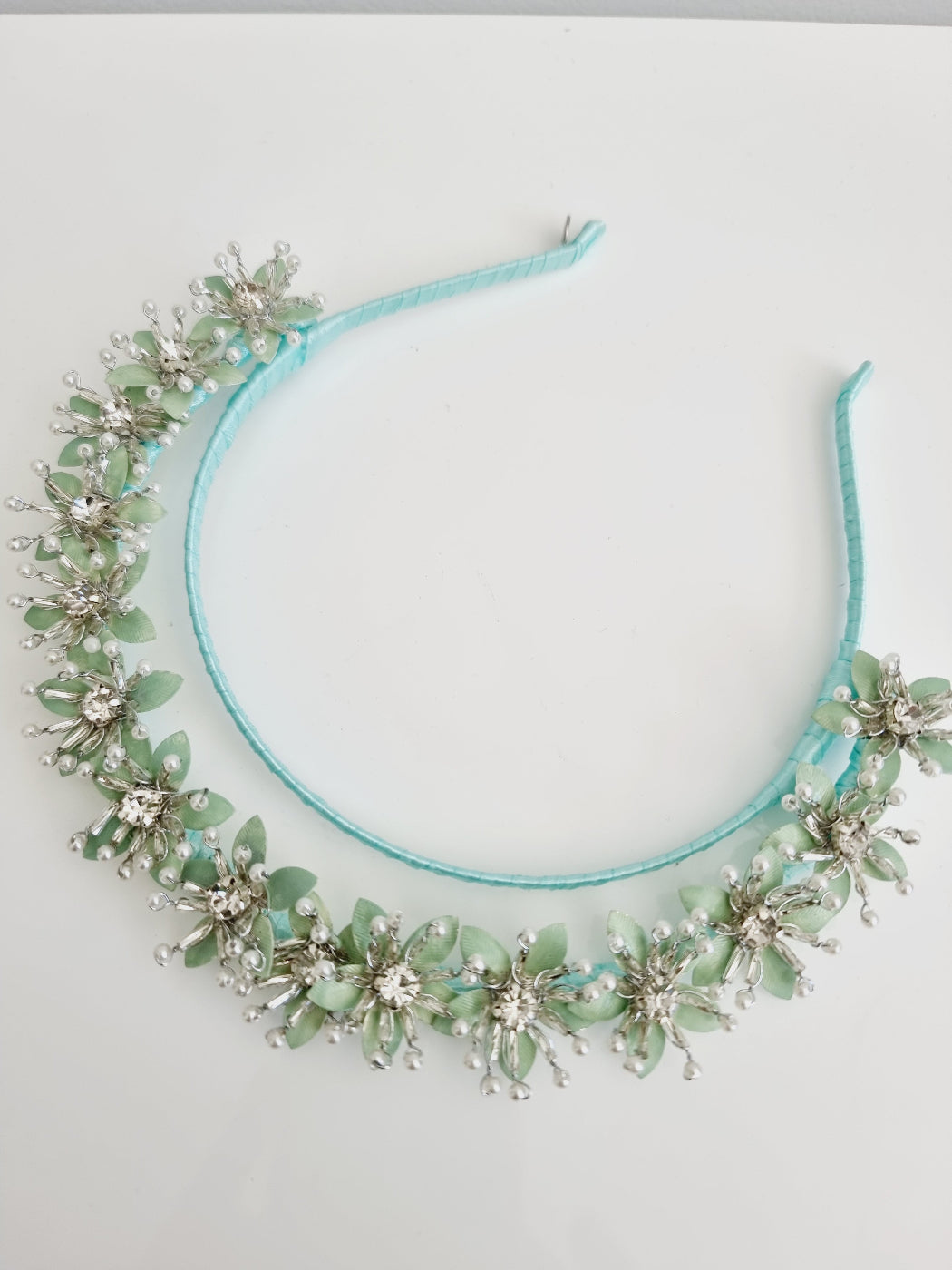 mint green flower headpiece flat lay