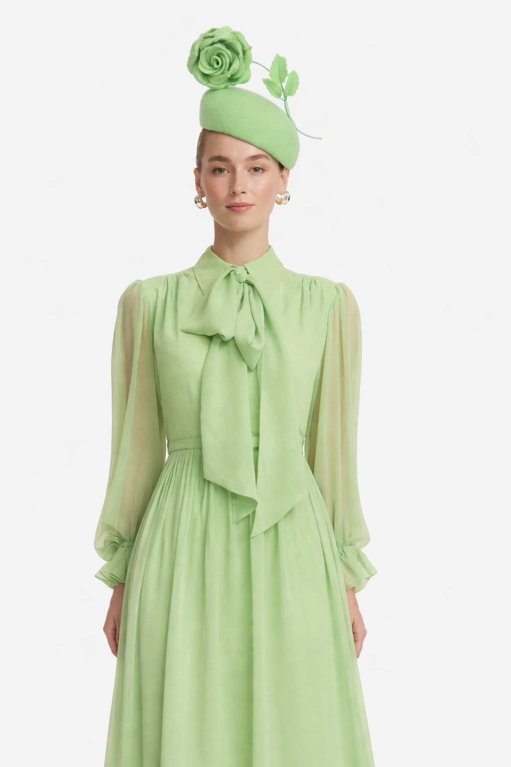 Woman wearing a light green dress with a matching hat on a white background