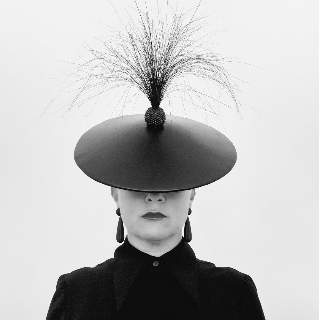 model wearing black hat