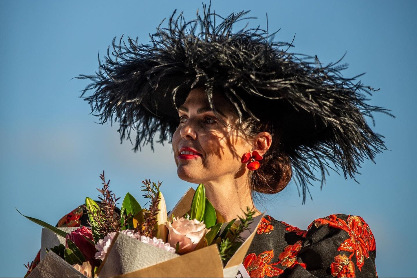 model wearing black ostrich feather hat