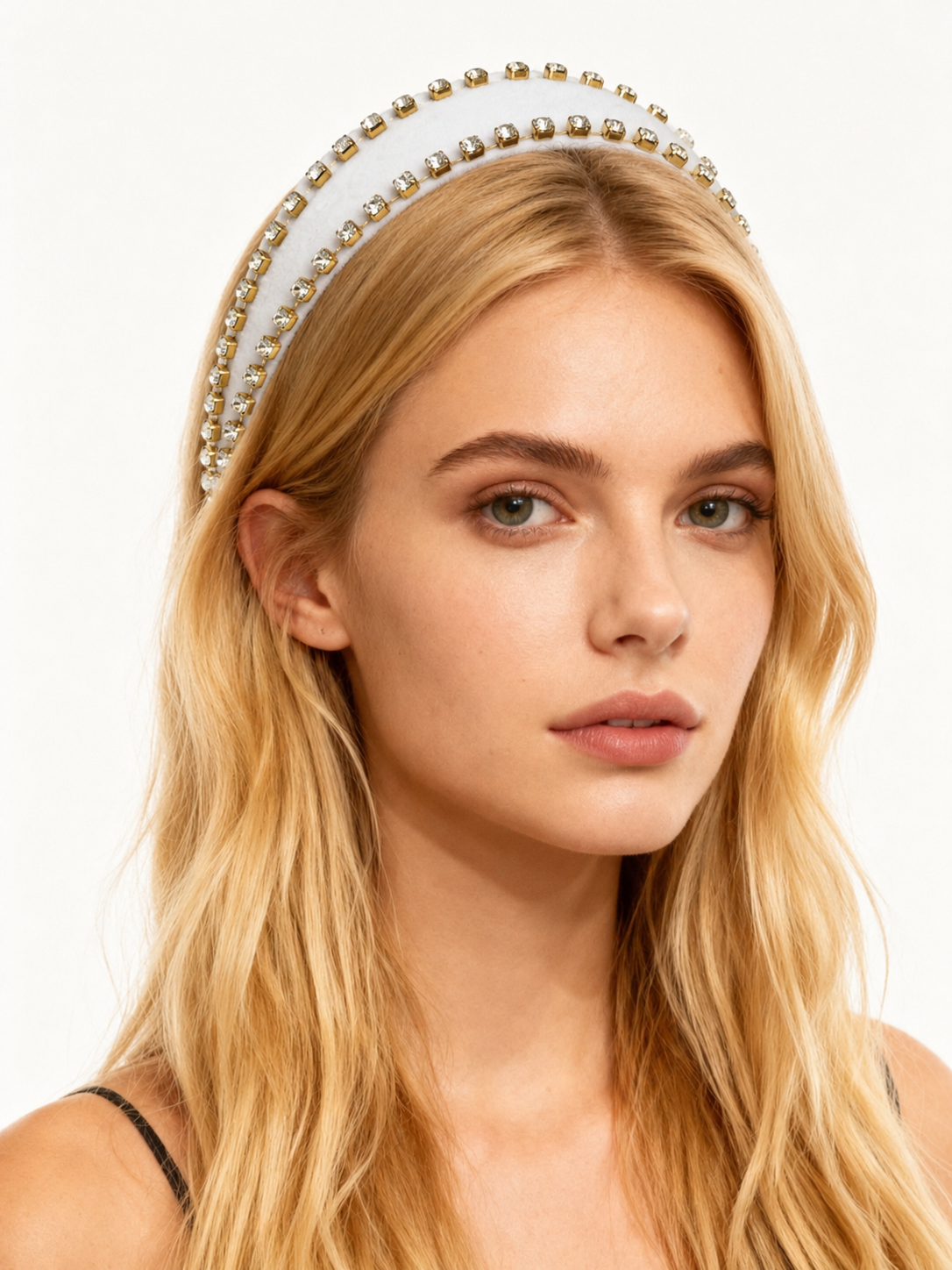 Woman wearing a decorative headband with a plain background