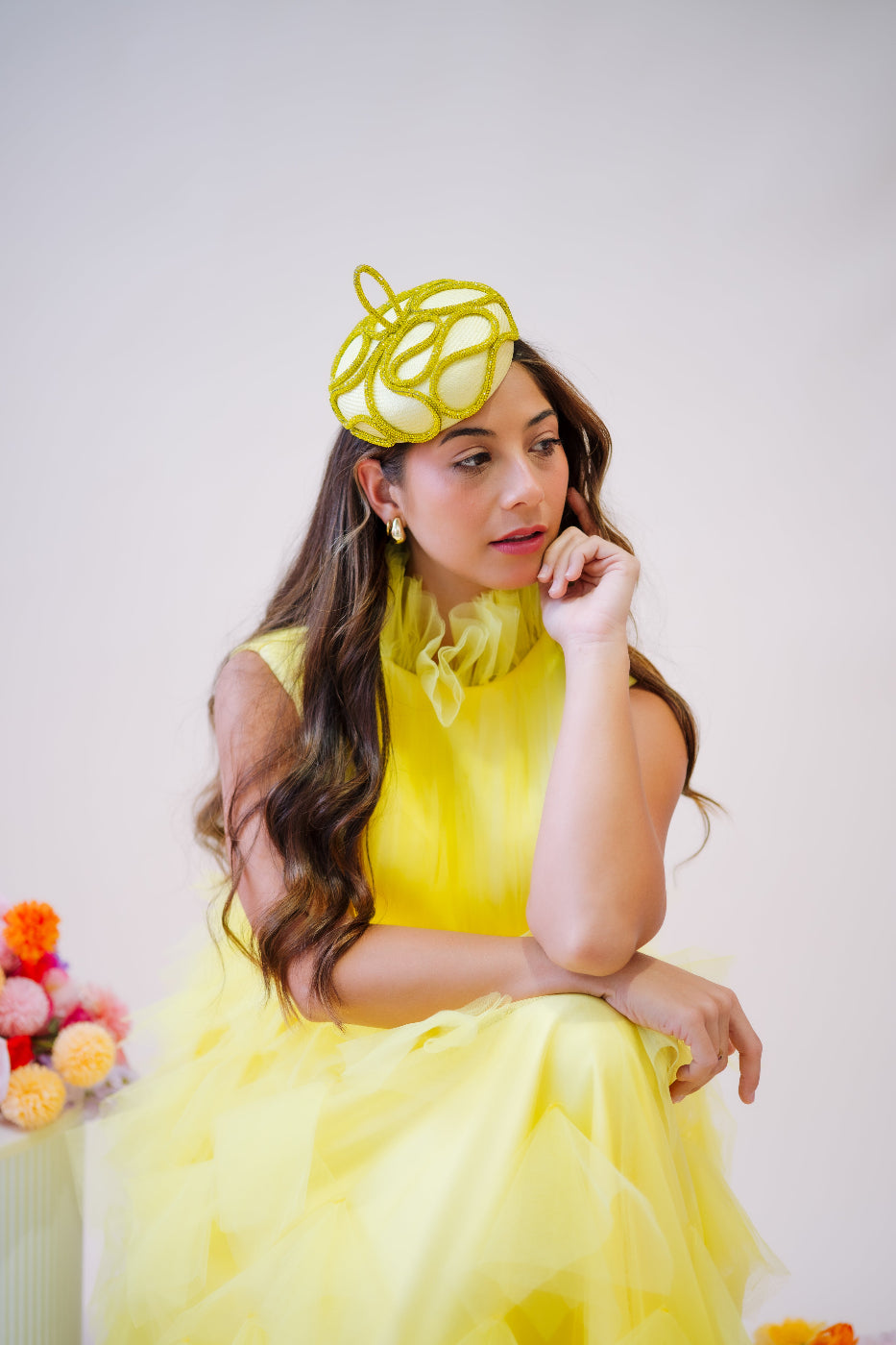 model wearing yellow button headpiece