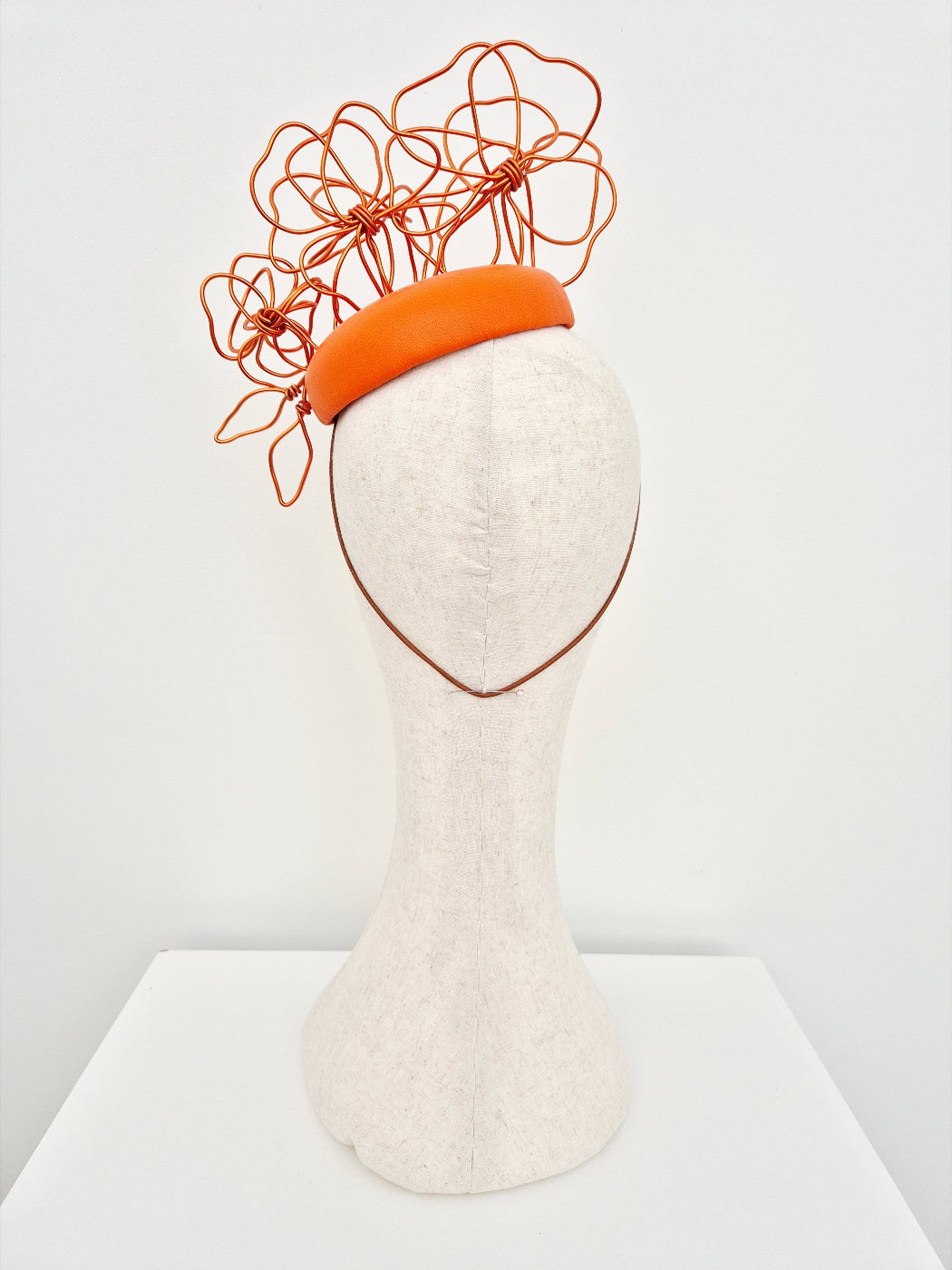 orange button headpiece with floral wirework back