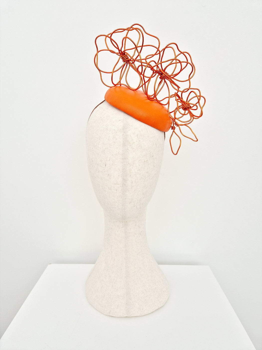 orange button headpiece with floral wirework
