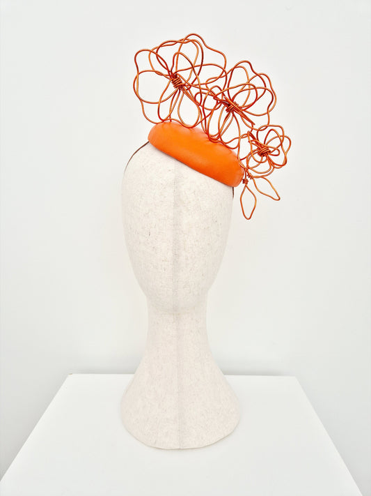 orange button headpiece with floral wirework