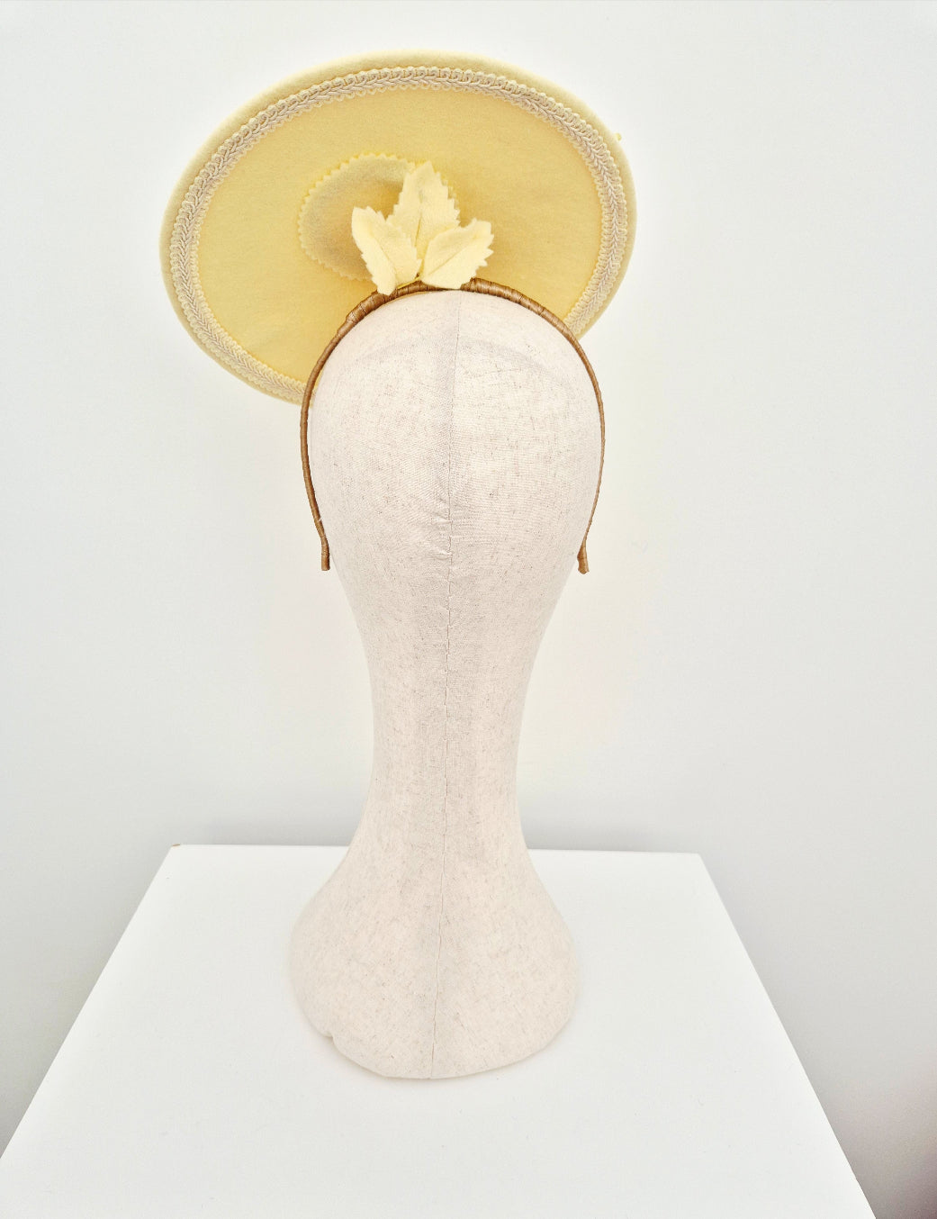 pale yellow headpiece back view on a manniquien head