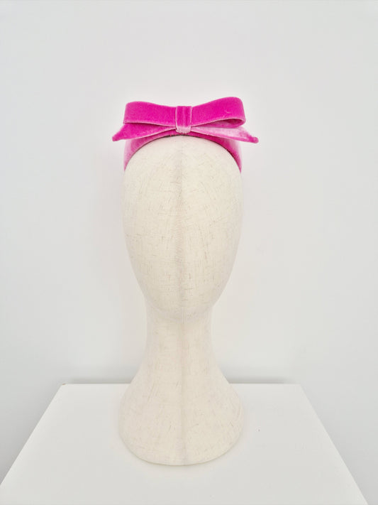 Mannequin head with a pink headpiece pillbox on a white background