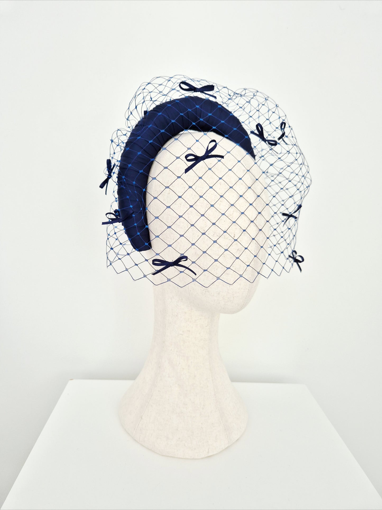 Miss Maria. Womens Navy Blue padded headband with veiling and bows