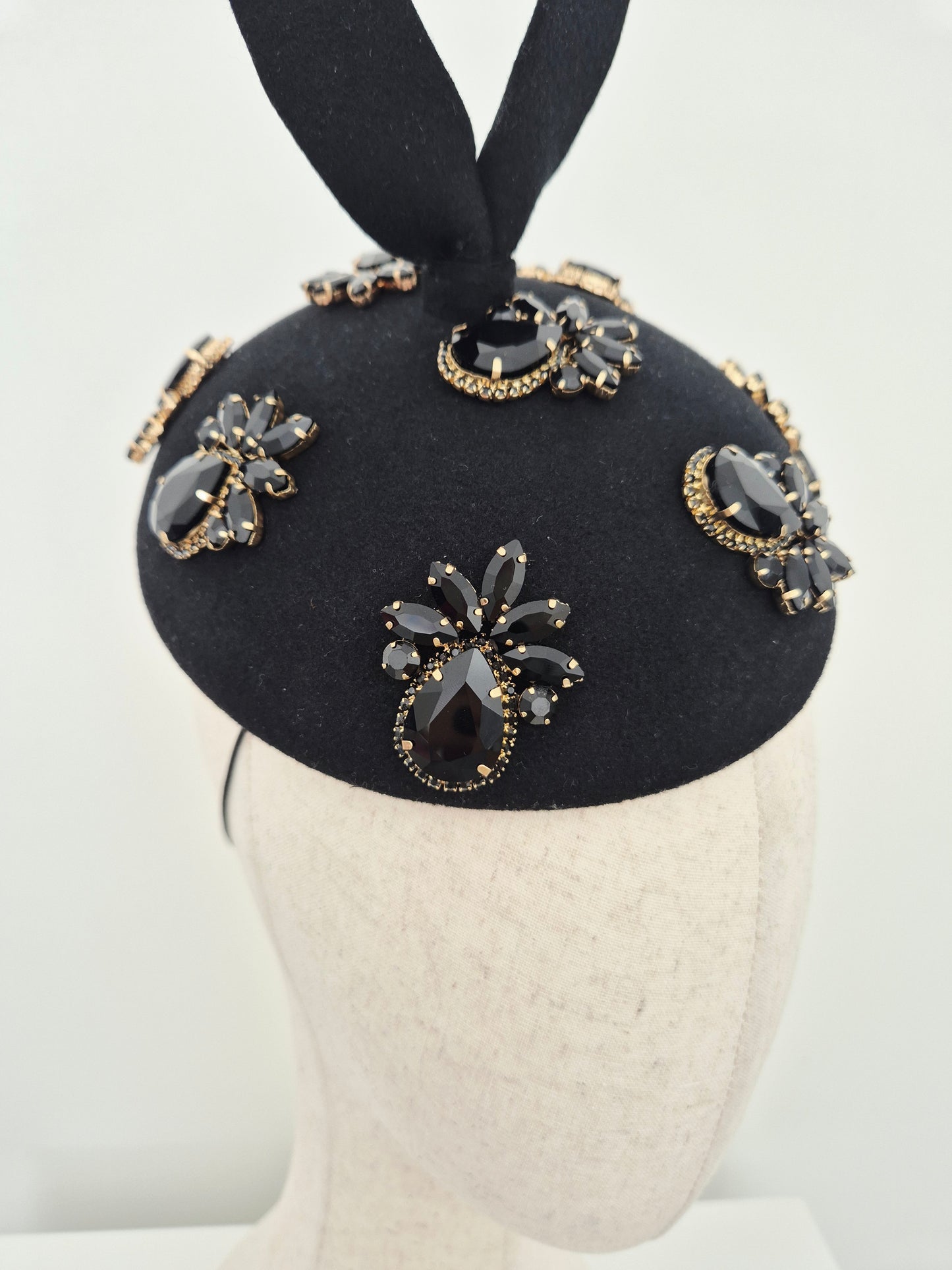 Miss Lesia. Black felt button headpiece with rhinestones and tail