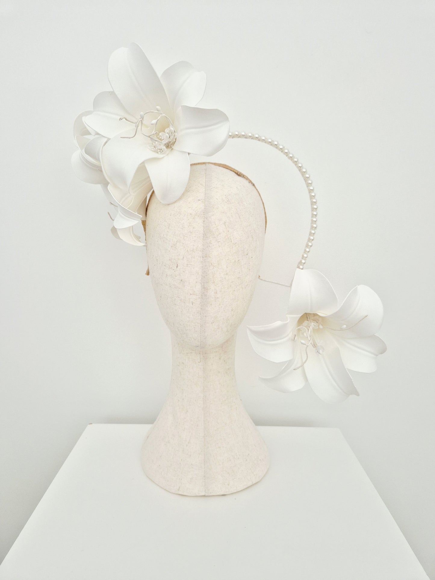 Miss Lilly. Womens white lilly floral cascading headpiece