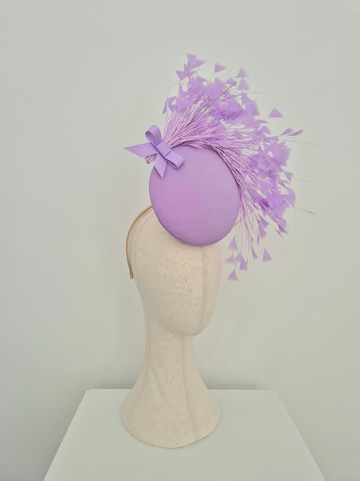 Miss Kim. Womens Lilac button percher headpiece with feather spray and bow