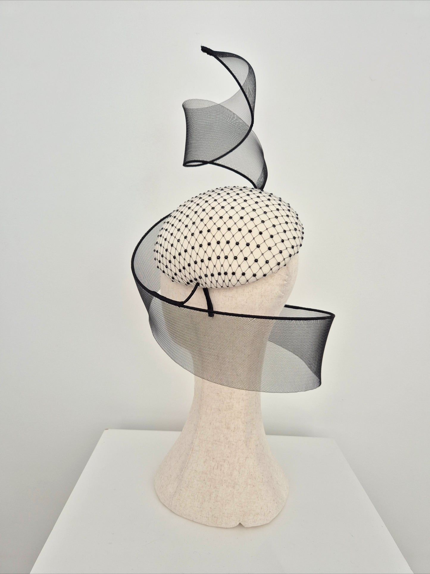 Miss Mabel. Womens Ivory and black felt headpiece with crinoline swirl