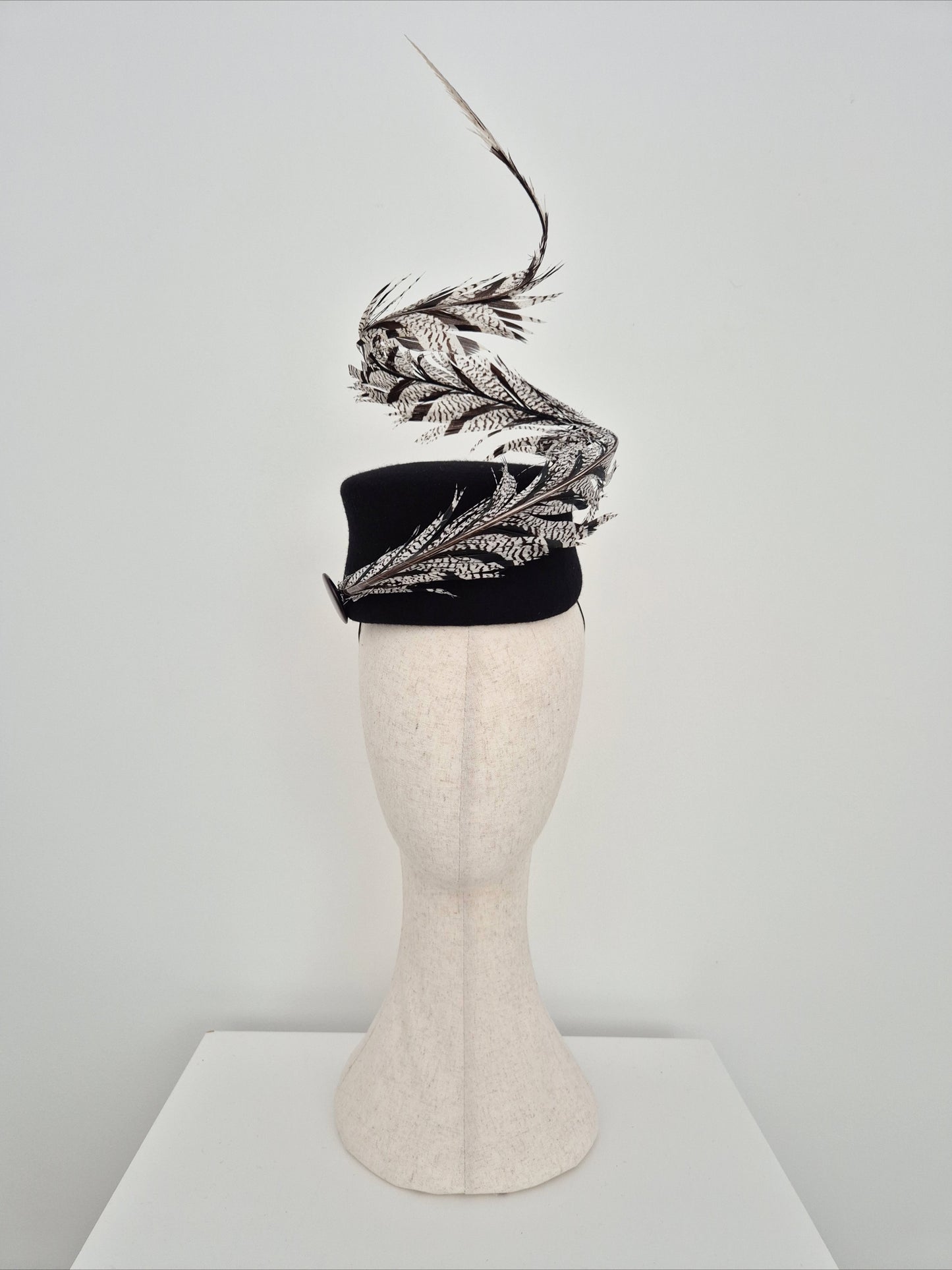 Miss Agatha. Womens black felt headpiece with spiral  feather