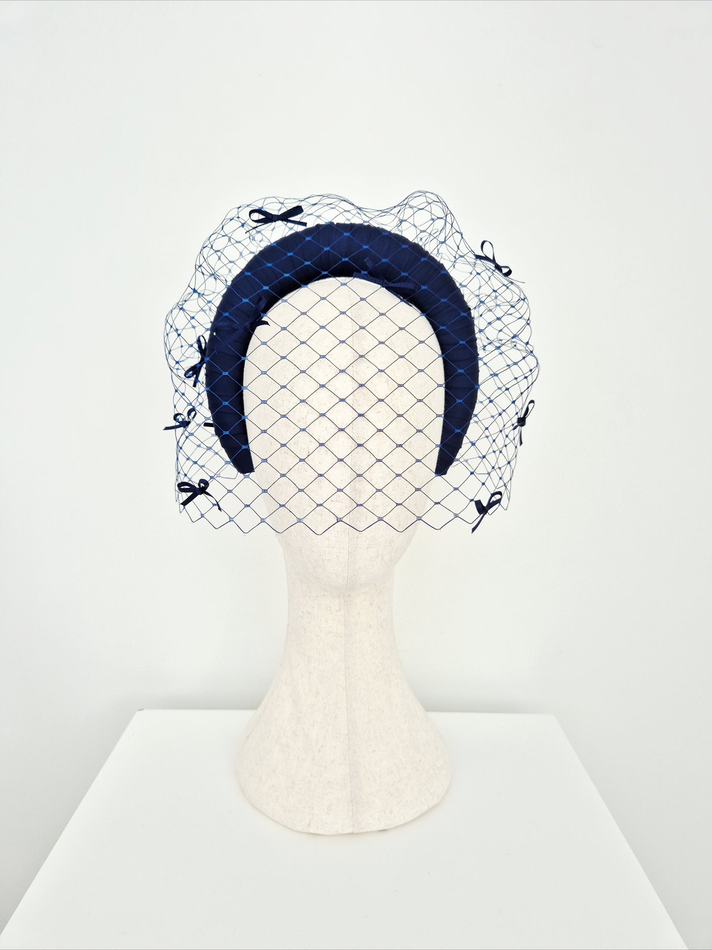 Miss Maria. Womens Navy Blue padded headband with veiling and bows