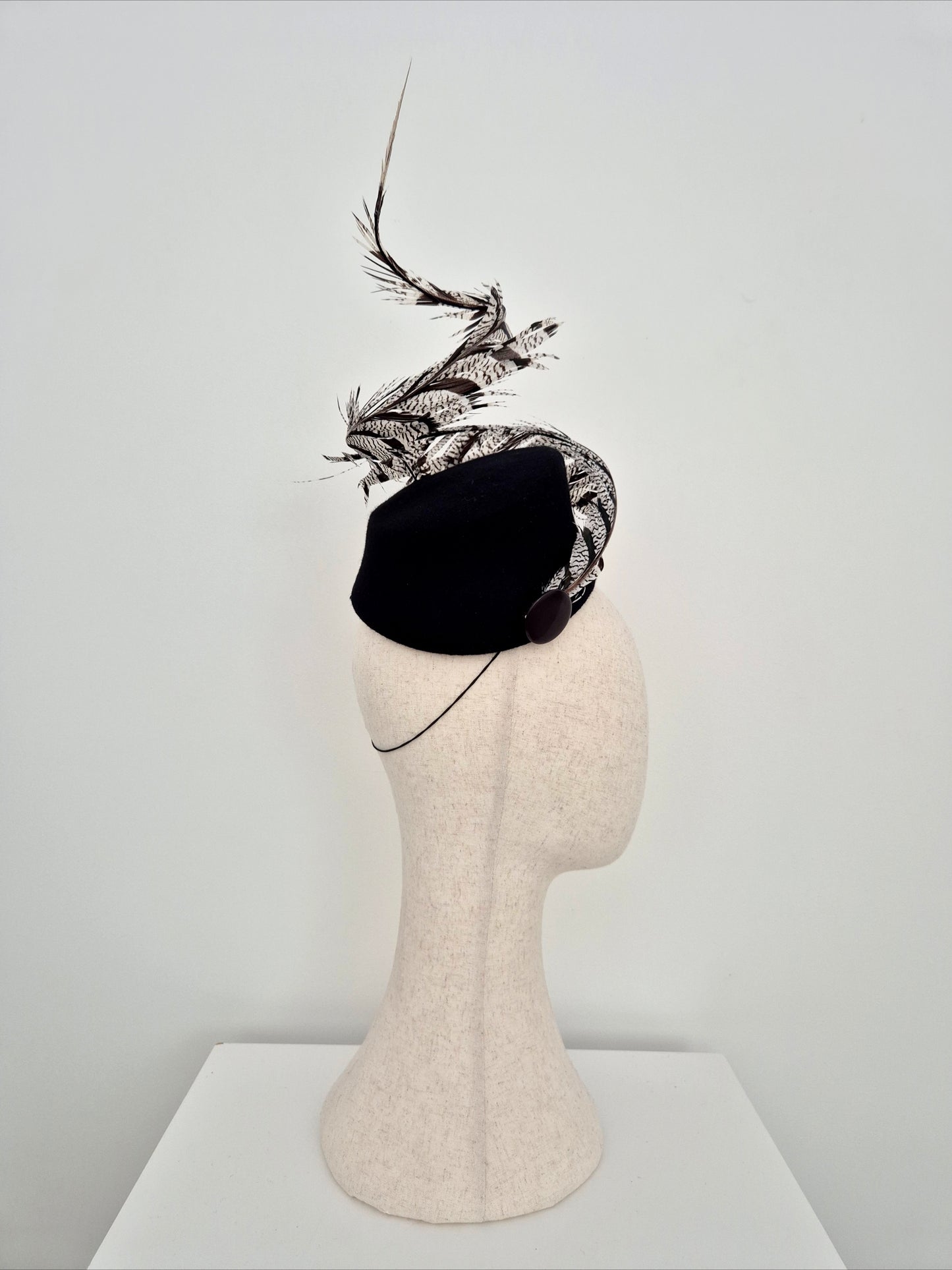 Miss Agatha. Womens black felt headpiece with spiral  feather