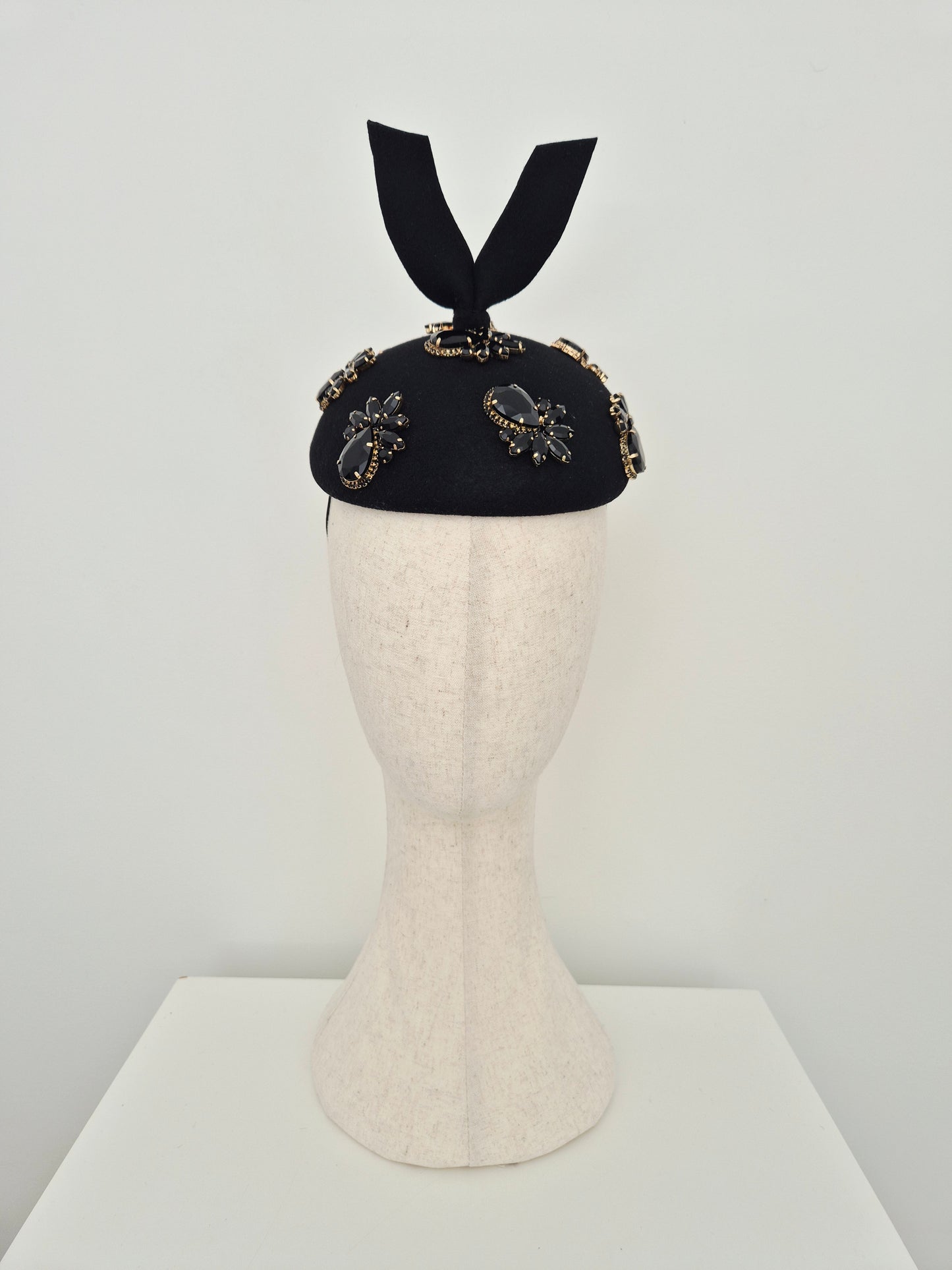Miss Lesia. Black felt button headpiece with rhinestones and tail