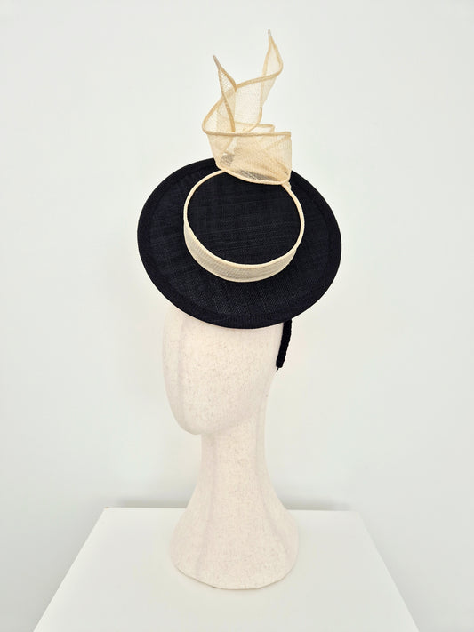 Miss Maya. Straw percher hat headpiece with a cream knotted swirl