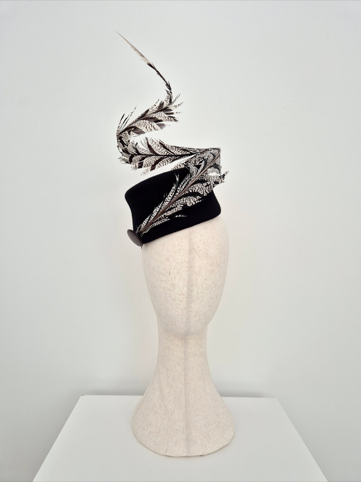 Miss Agatha. Womens black felt headpiece with spiral  feather