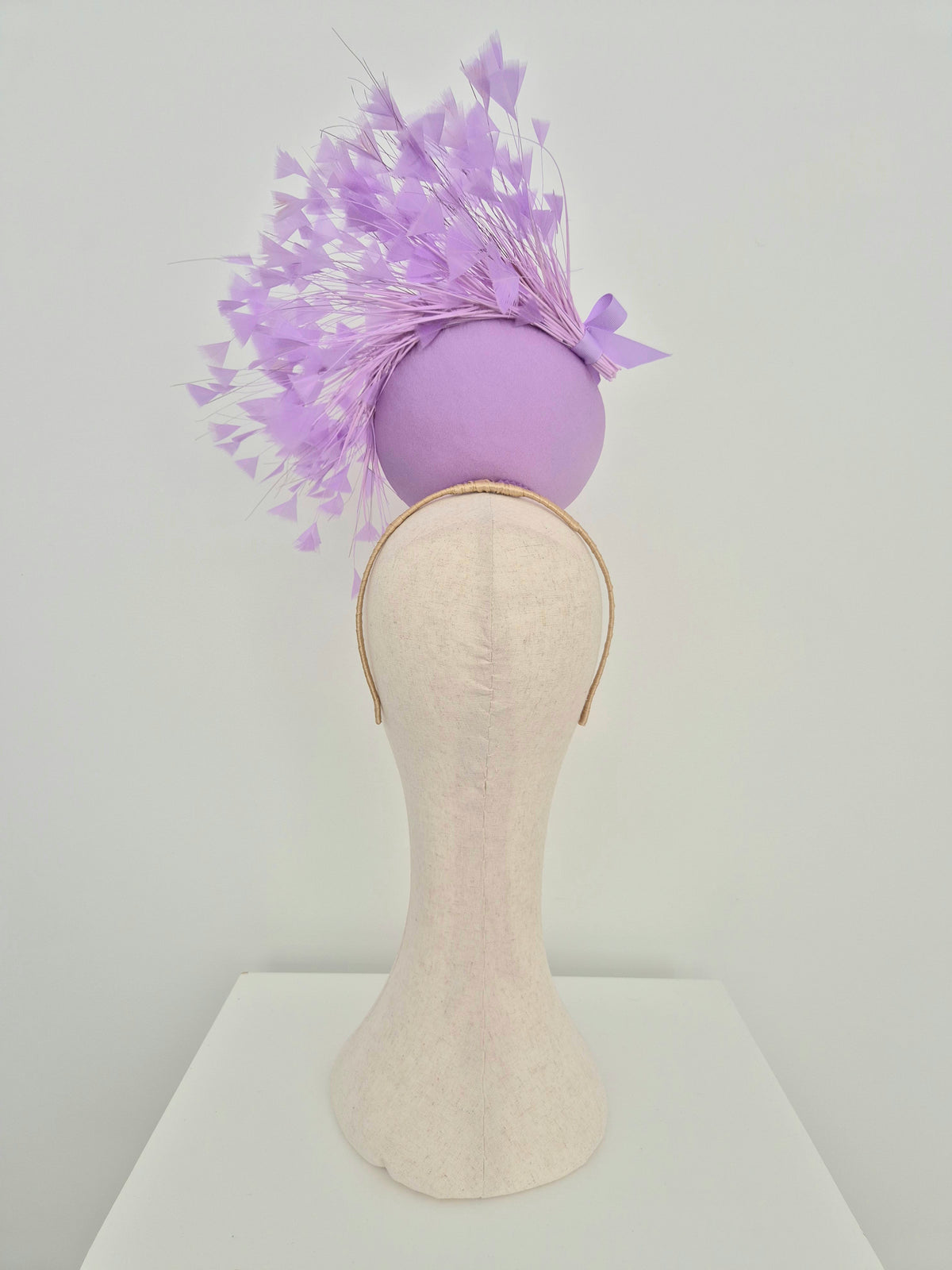 Miss Kim. Womens Lilac button percher headpiece with feather spray and bow