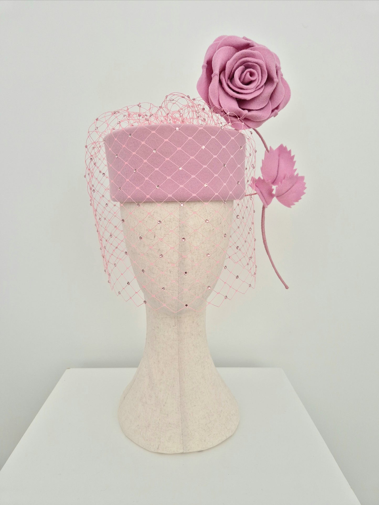 Miss Sabrina .Pink felt pillbox headpiece with rhinestone veiling and floating rose