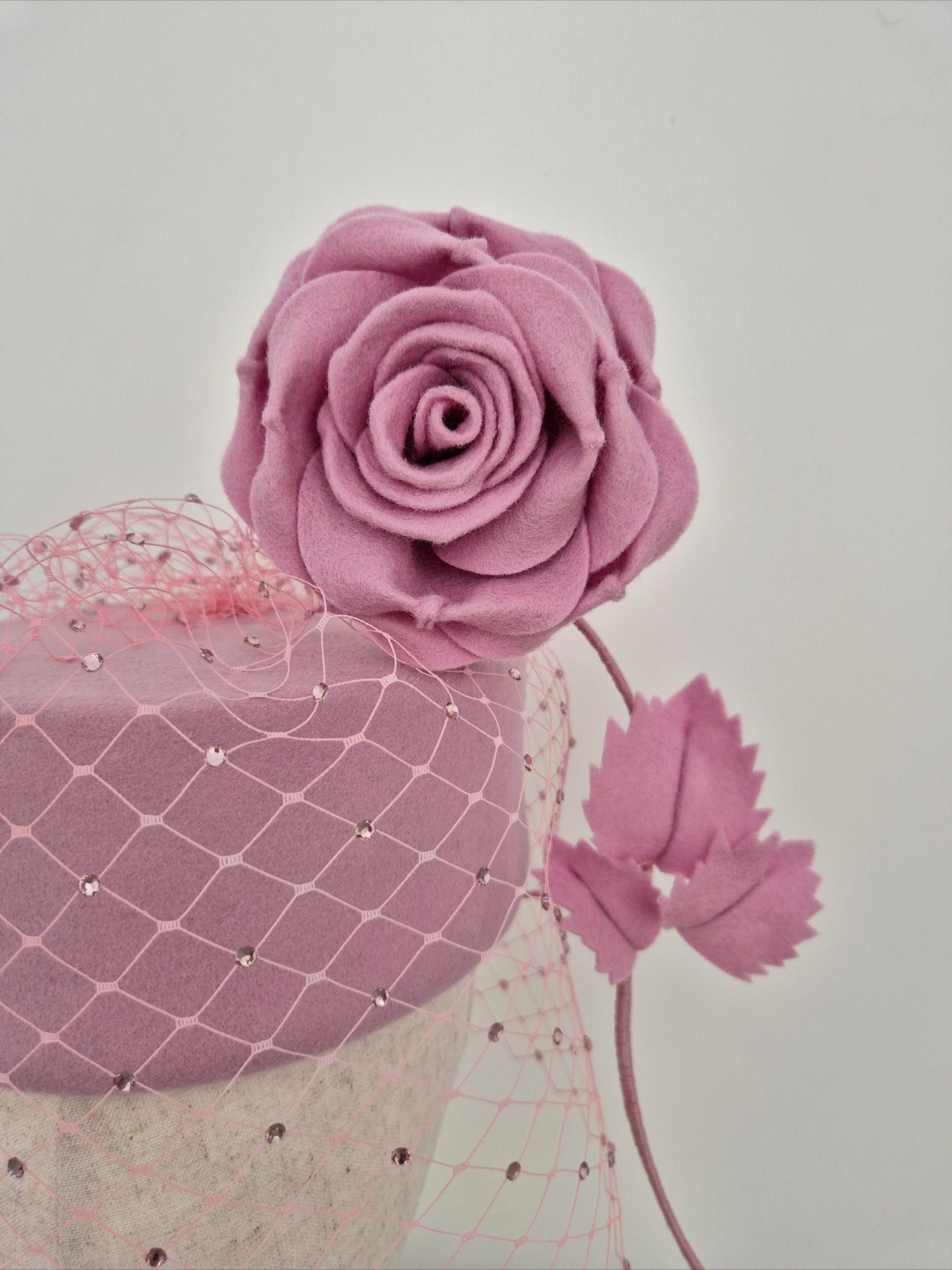 Miss Sabrina .Pink felt pillbox headpiece with rhinestone veiling and floating rose