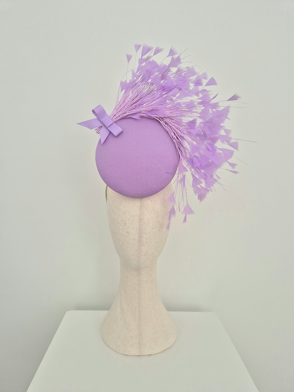 Miss Kim. Womens Lilac button percher headpiece with feather spray and bow
