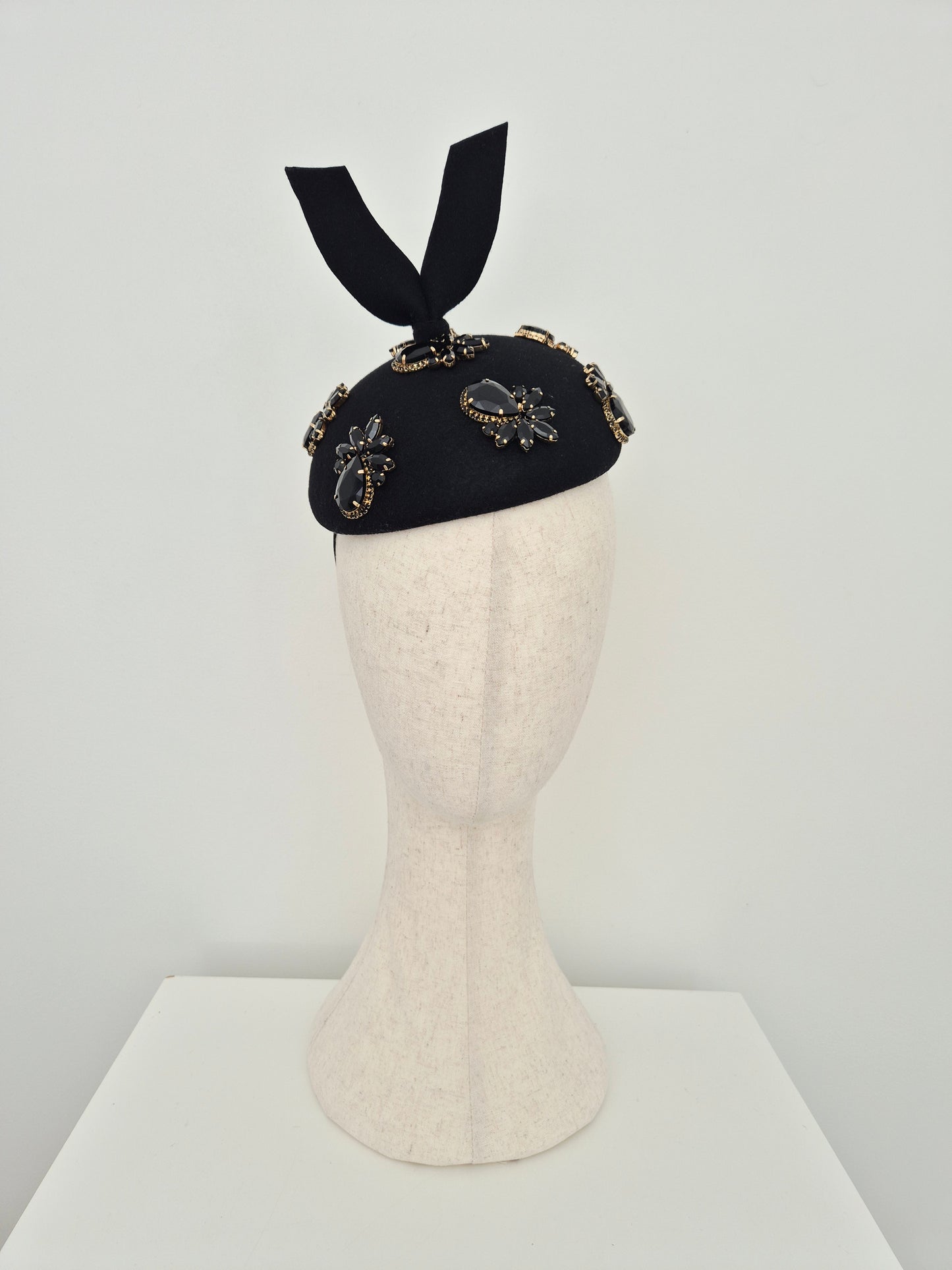 Miss Lesia. Black felt button headpiece with rhinestones and tail