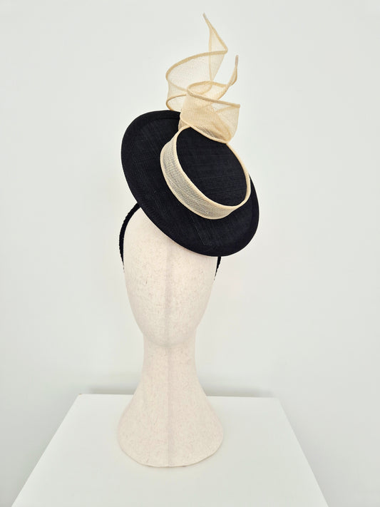 Miss Maya. Straw percher hat headpiece with a cream knotted swirl