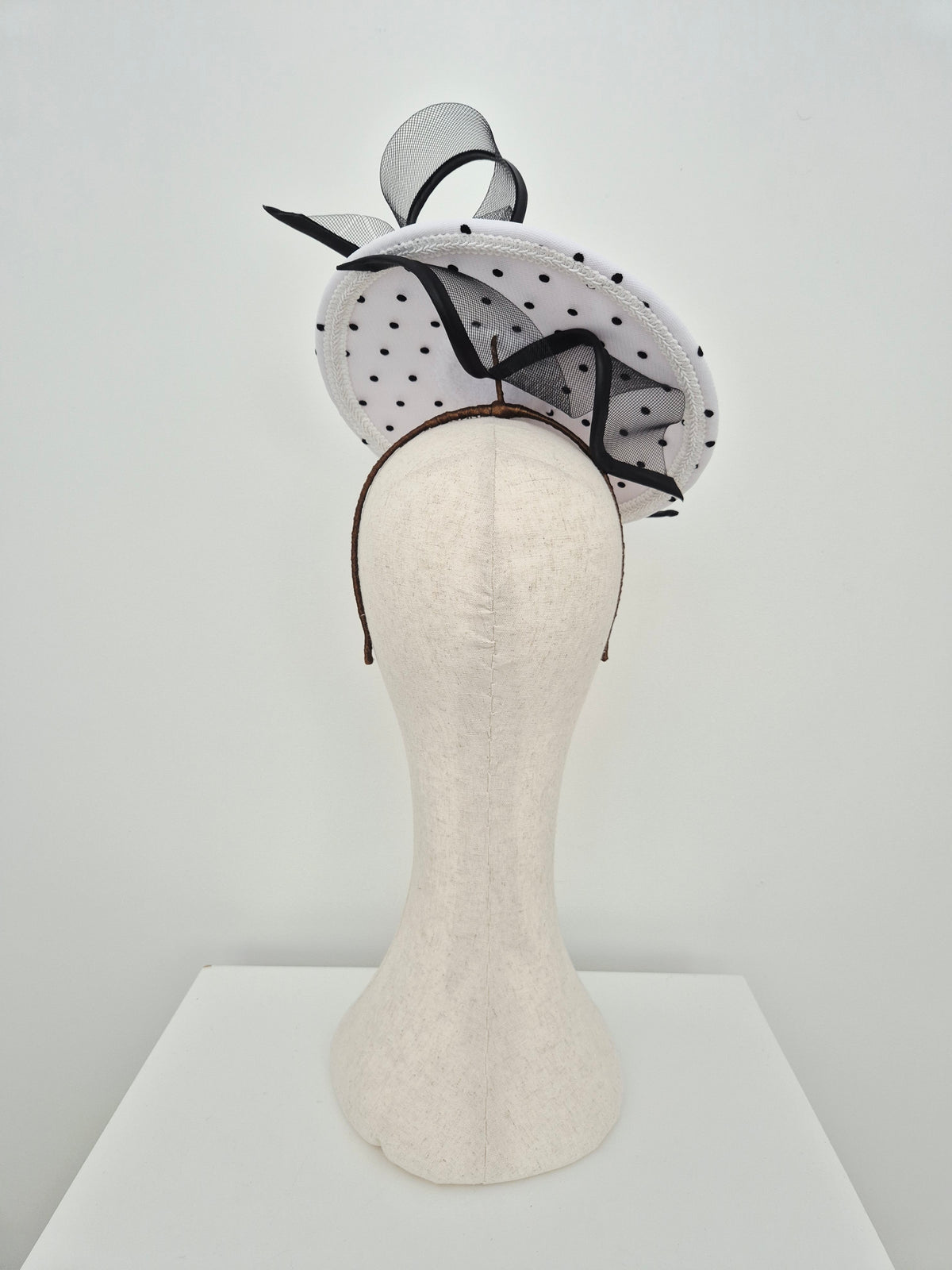 Miss Belle . Womens polka dot floating disk petcher headpiece with swirl