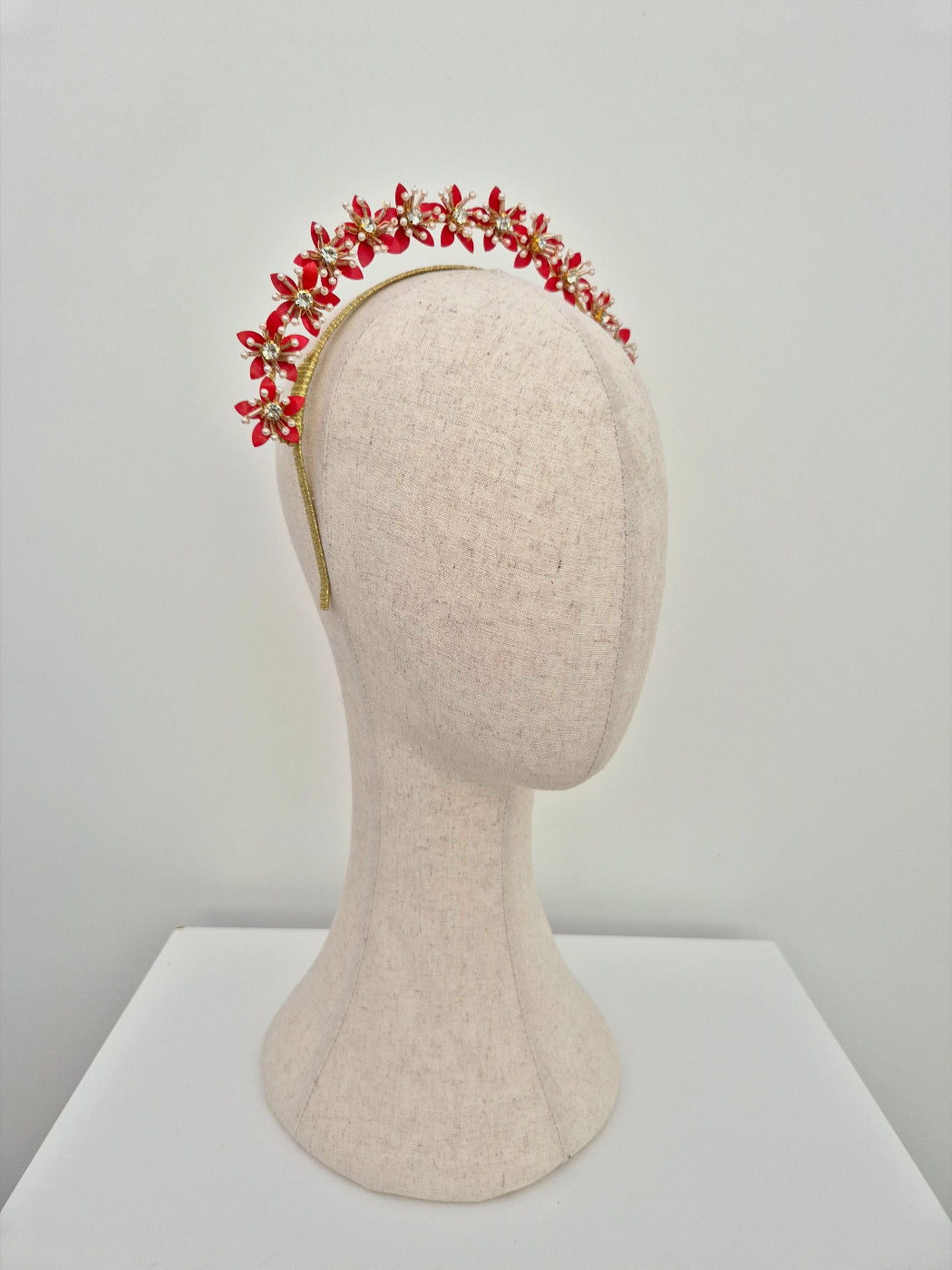 side view of gold and red floral headpiece
